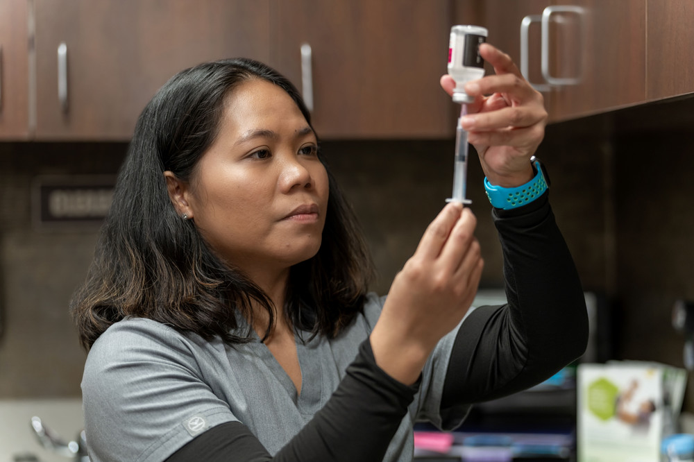 Apprentice Aisa Pisha prepares an injection at the Cornerstone Medical Group. Pisha plans to graduate in December and continue working for Cornerstone Medical.